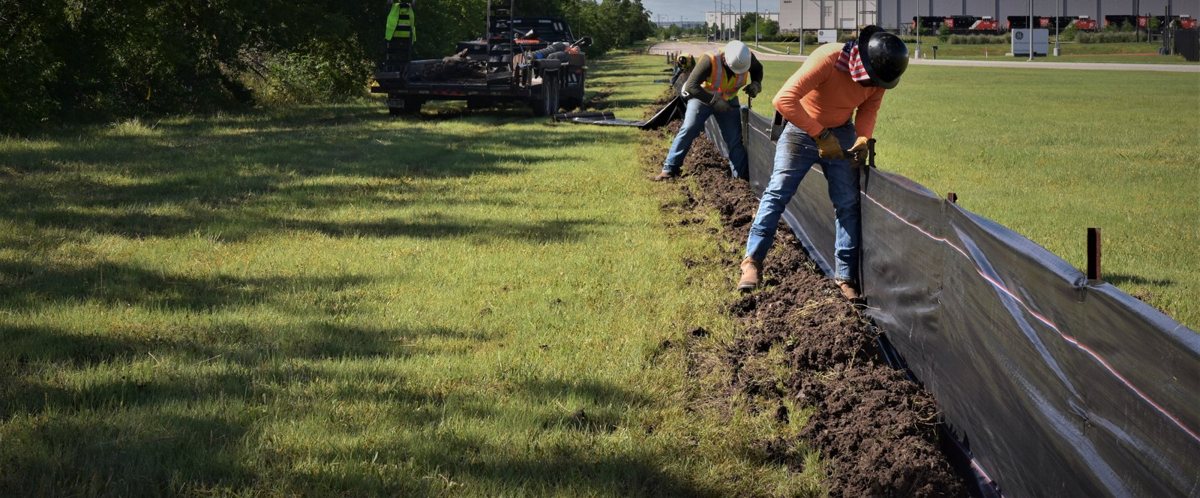 Terradyne crew driving T-posts for silt fence installation