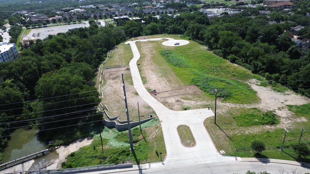 Aerial view of a graded construction pad with perimeter controls in place
