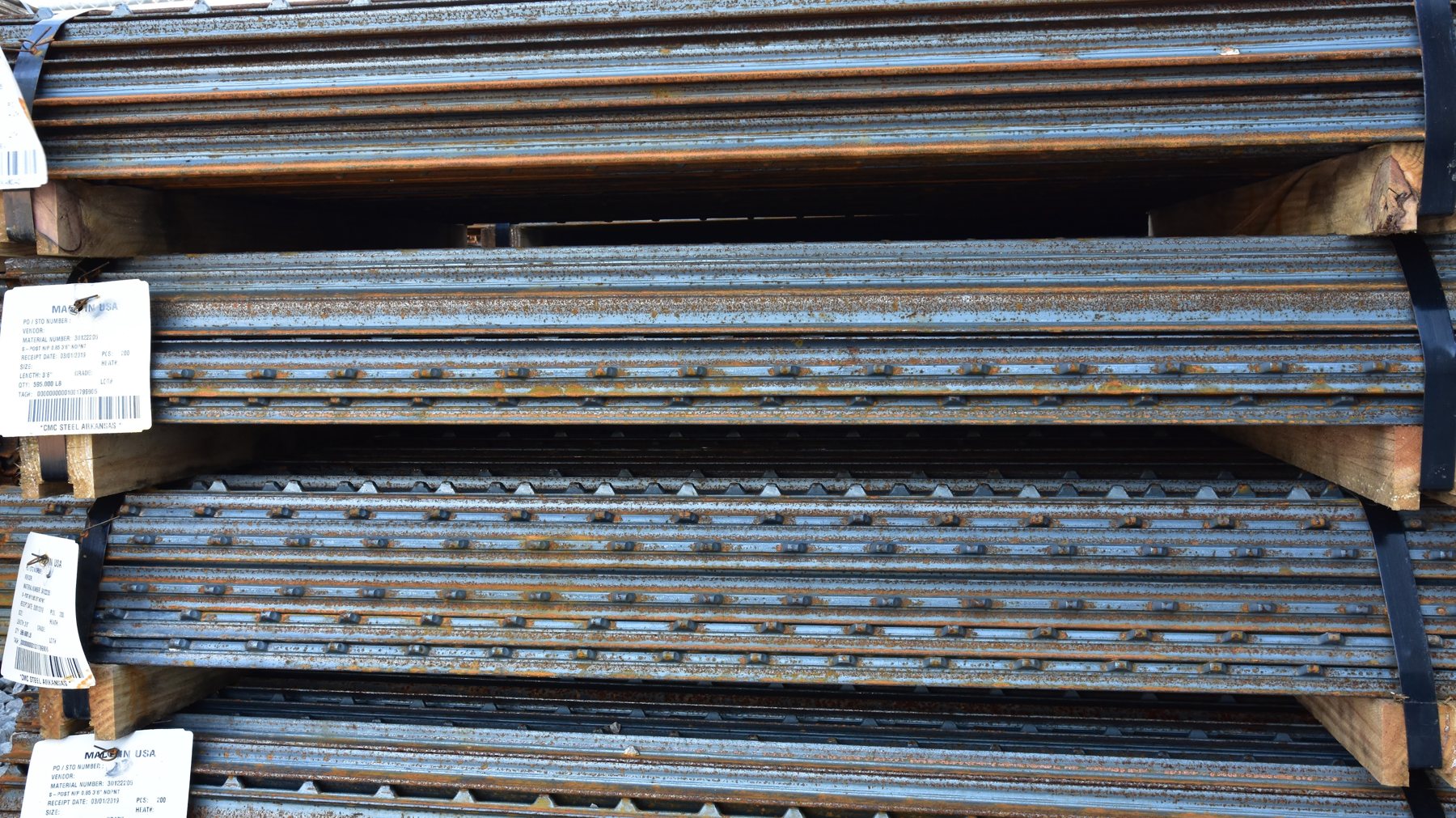 Bundles of metal T-posts staged for silt fence installation