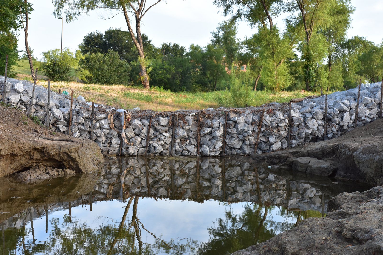 Rock filter dam built across a creek channel to slow concentrated flow