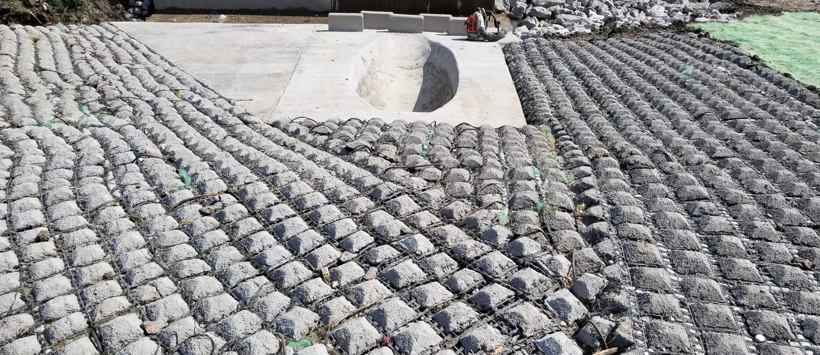 Flexamat tied concrete block matting installed on a slope beside a flume