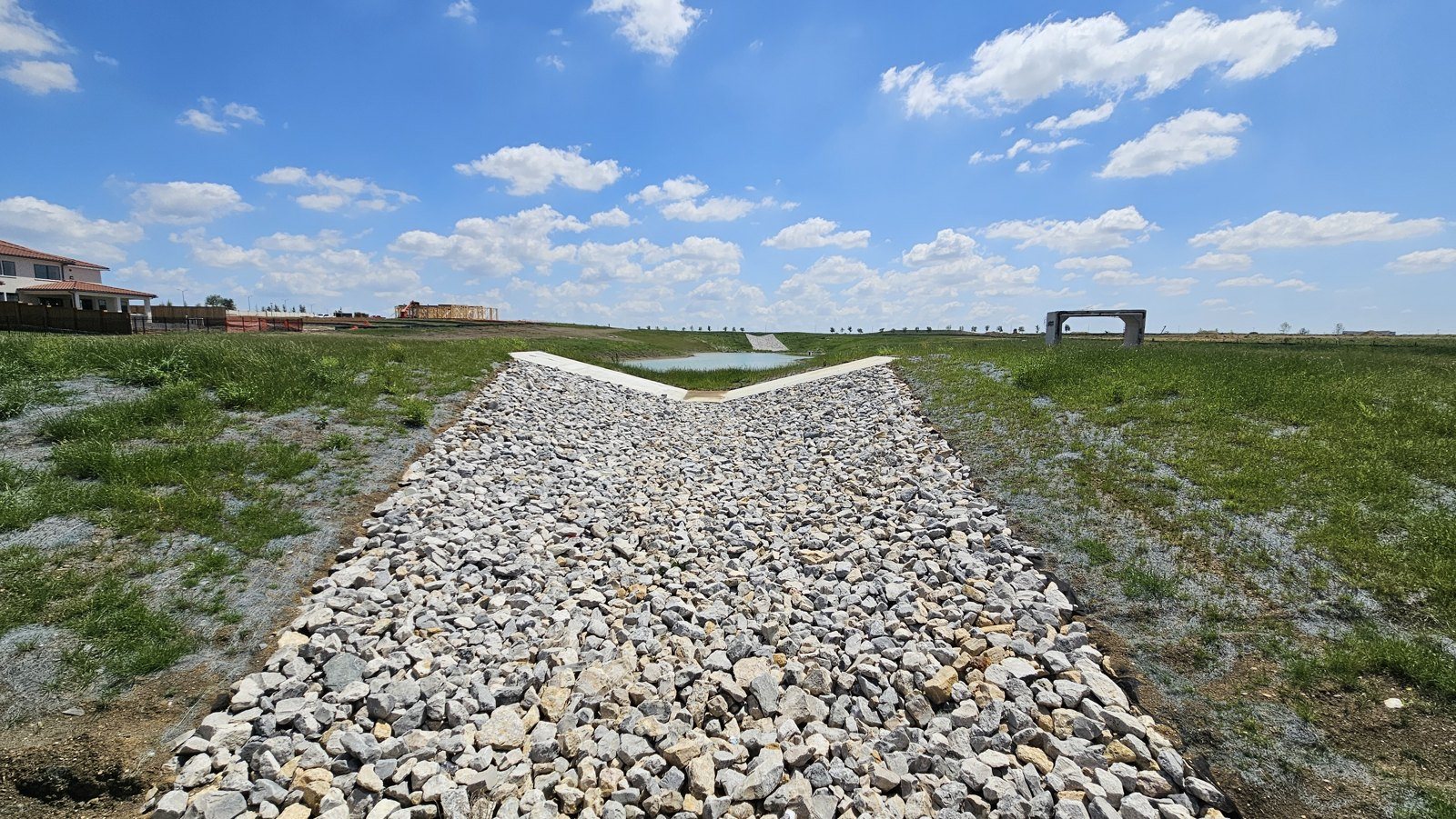 Riprap chute carrying flow through an established grass channel