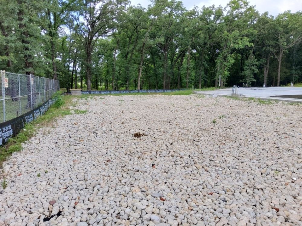 Clean washed rock construction entrance at a site access point