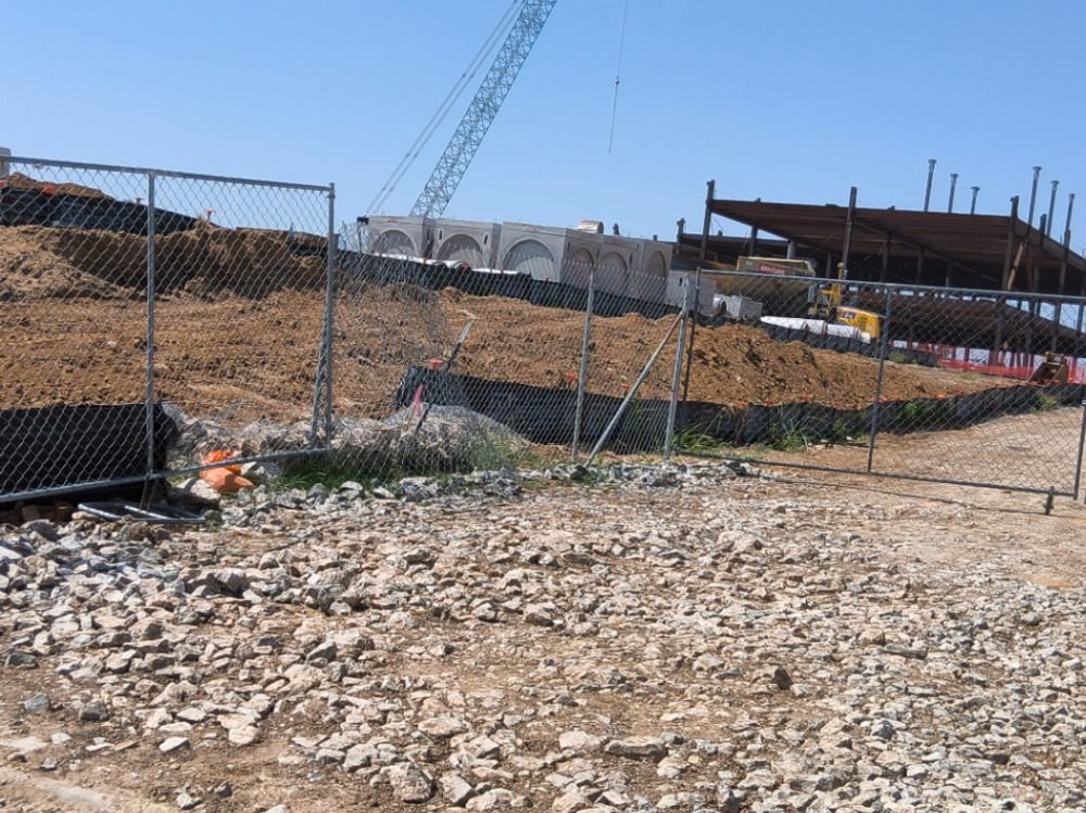 Rock construction exit and a blanketed slope on an active Dallas County commercial build
