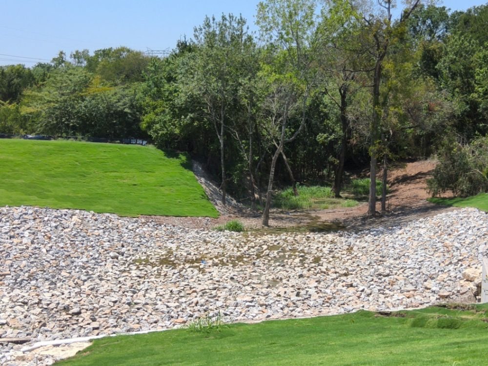 Rip-rap channel lining and sodded slopes protecting a Collin County drainage way