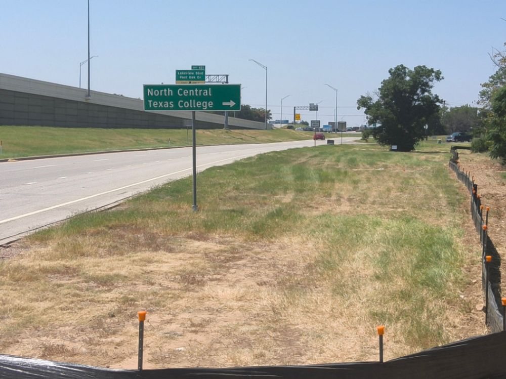 Established vegetation and a capped silt fence line along a Denton County highway frontage