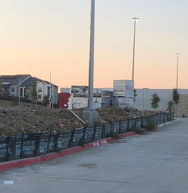 Terradyne branded silt fence along a curb line on a Fort Worth retail development