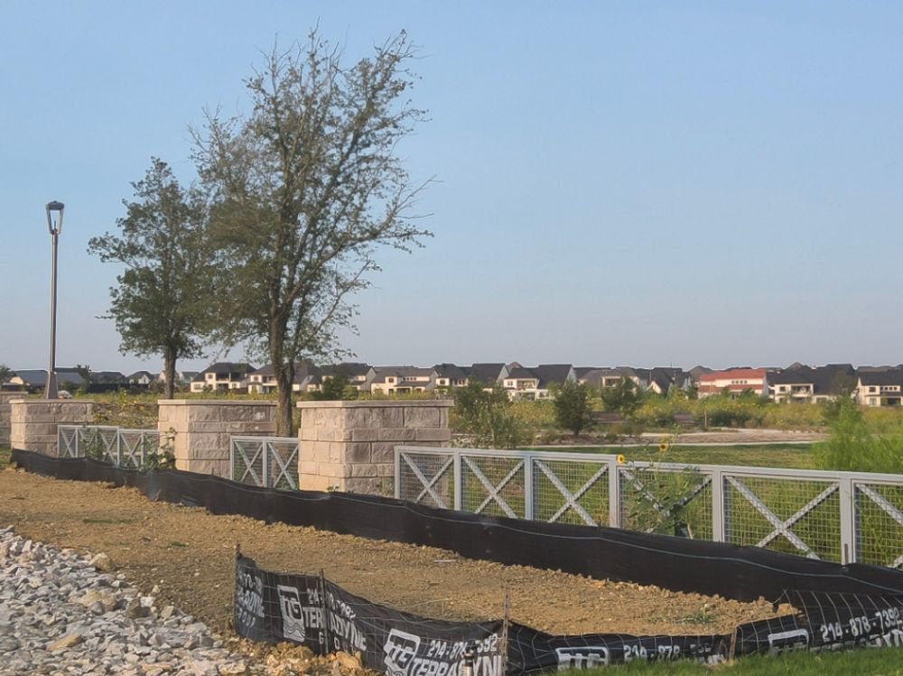 Terradyne branded silt fence at the entrance to a Frisco residential development