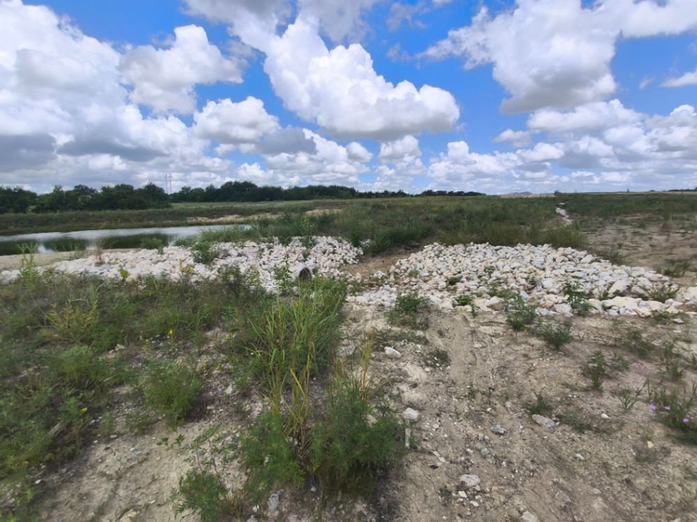 Rip-rap outfall aprons discharging to a detention pond on a Grayson County construction site