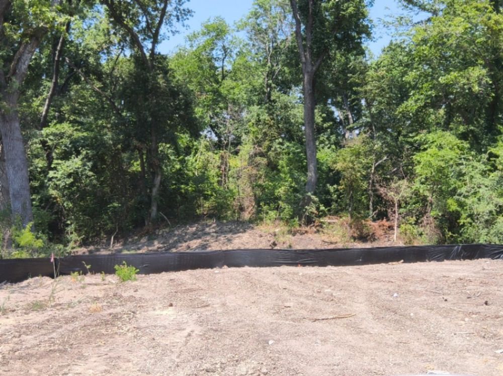 Silt fence along a wooded edge on a graded McKinney pad