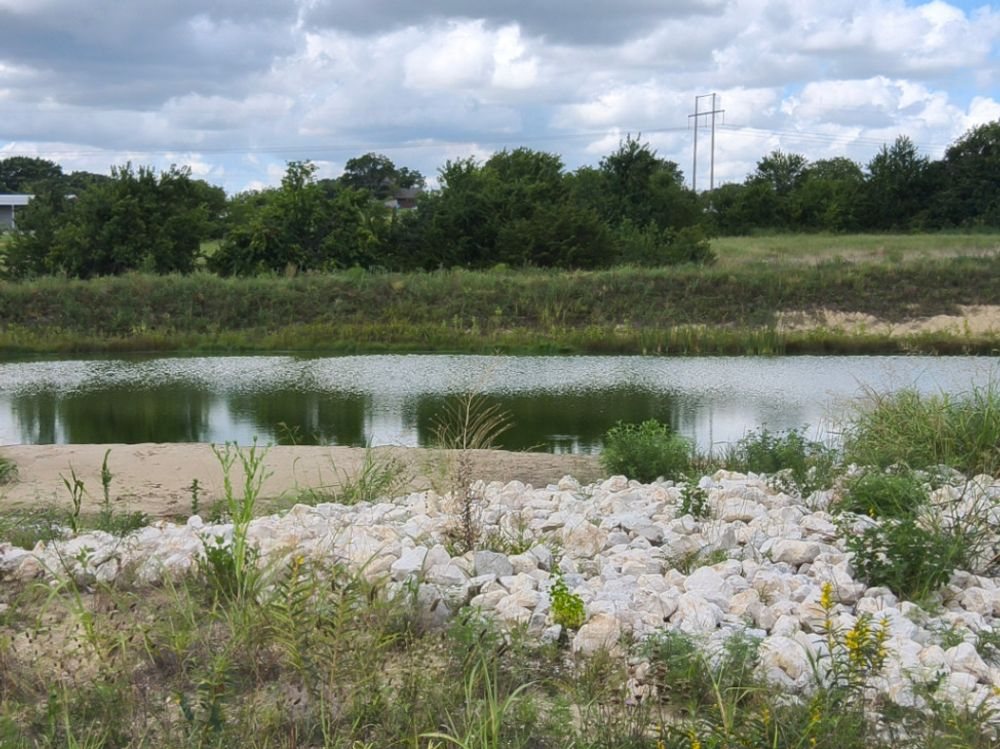 Rip-rap slope protection along a detention pond on a Grayson County construction site