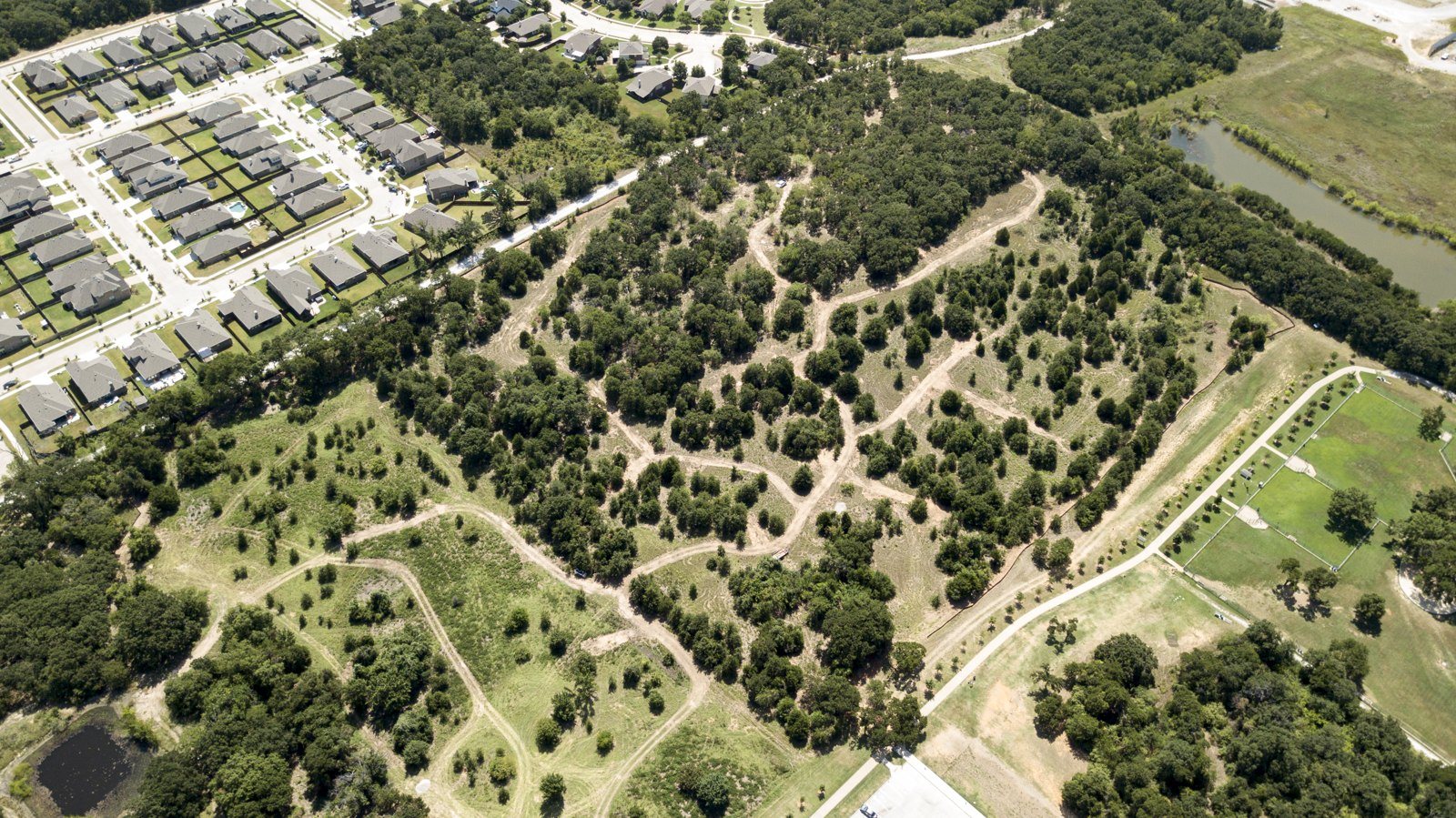 Aerial view of wooded acreage before clearing and mowing