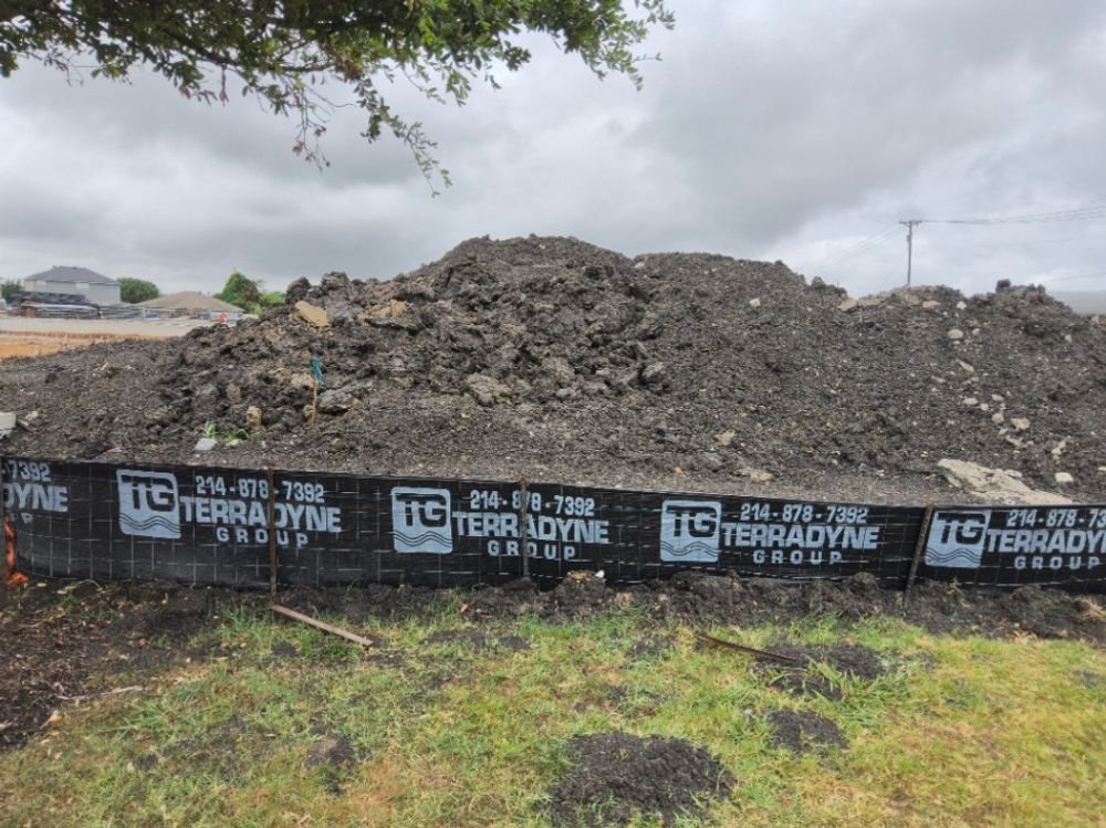 Soil stockpile contained by Terradyne branded silt fence ahead of removal