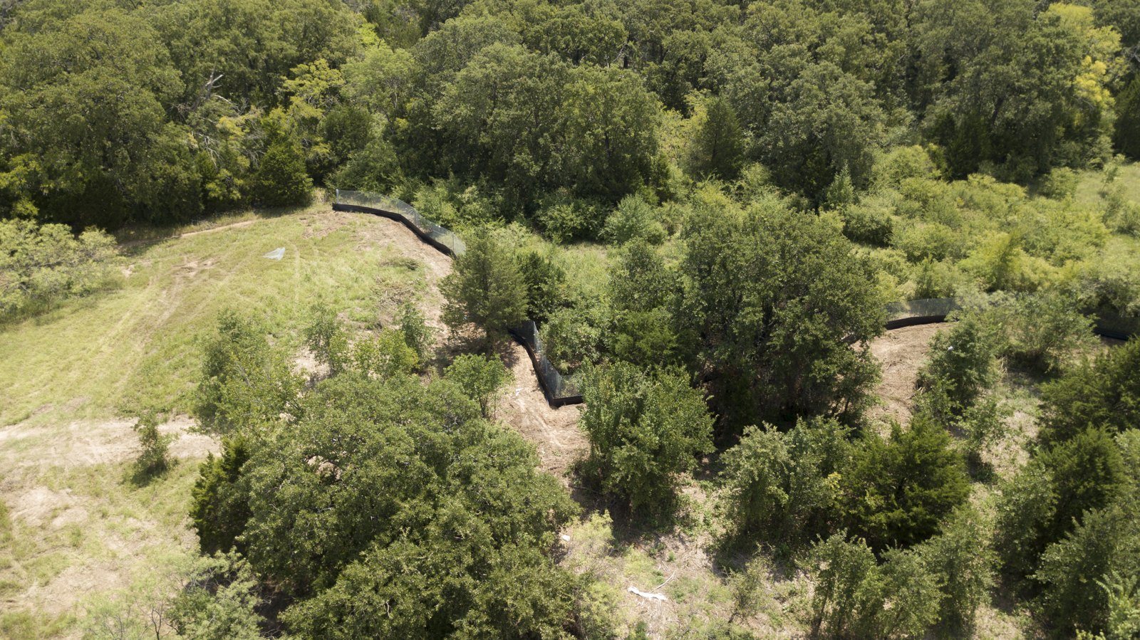Aerial view of silt fence lines tracing the terrain of a development site